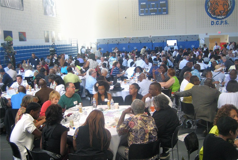 A photograph of more than 100 participants at the Ward 8 Community Summit in a D.C. public school gymnasium.