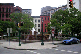 A photograph of townhouses and a city square.