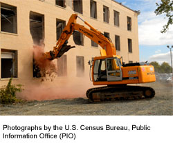 A picture of an abandoned multifamily housing development being demolished.