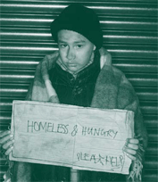 A picture of a homeless kid holding a handwritten sign that says 'Homeless and Hungry, Please help'.