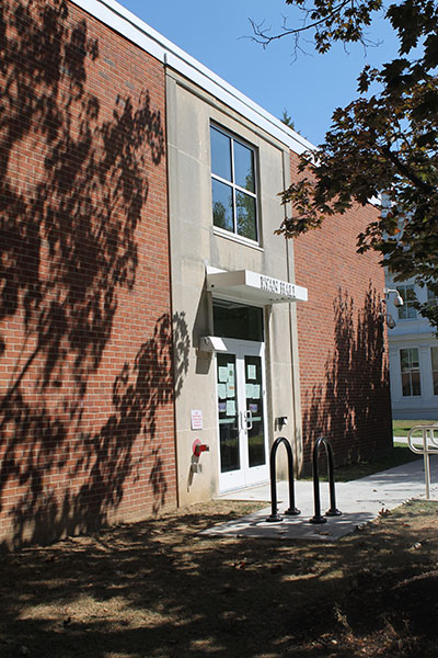 Photograph of the entrance to a two-story brick school building.
