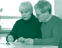 A picture of a social worker helping a resident select services he needs to live independently.