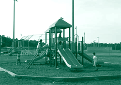 A picture of a play area shared in common by families of a housing complex.