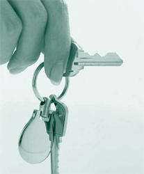 A picture of a ring of house keys in a person's hand.