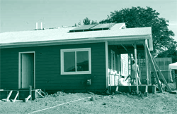 A picture of a home on which solar panels convert solar energy for household use.
