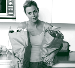 A picture of a woman holding bags of groceries she has bought for her housemate in exchange for reduced rent, per their home sharing contract. A picture of a woman holding bags of groceries she has bought for her housemate in exchange for reduced rent, per their home sharing contract.