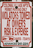 Close-up of no parking sign that reads, "Violators Towed At Owner's Risk and Expense"