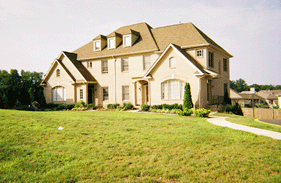 Photograph of beige brick quadraplex.