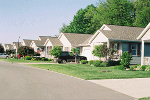 A photograph of a streetscape with single-family homes.