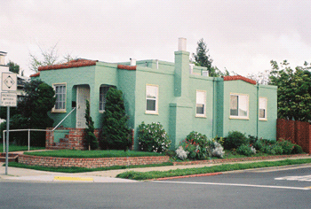 A photograph of green stucco house.