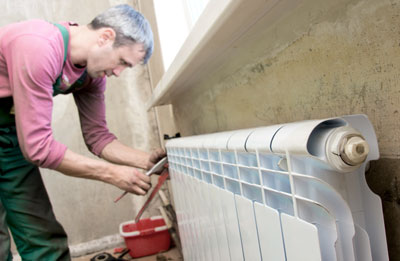 A technician installs a new, energy-efficient heating element. Image courtesy of Shcherbakov Ilya.