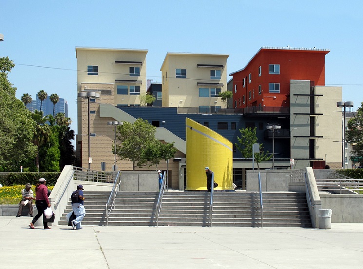 Photograph taken at street level looking east over the Westlake/MacArthur Park Metro station to the four- and five-story buildings in MacArthur Park Apartments Phase A.